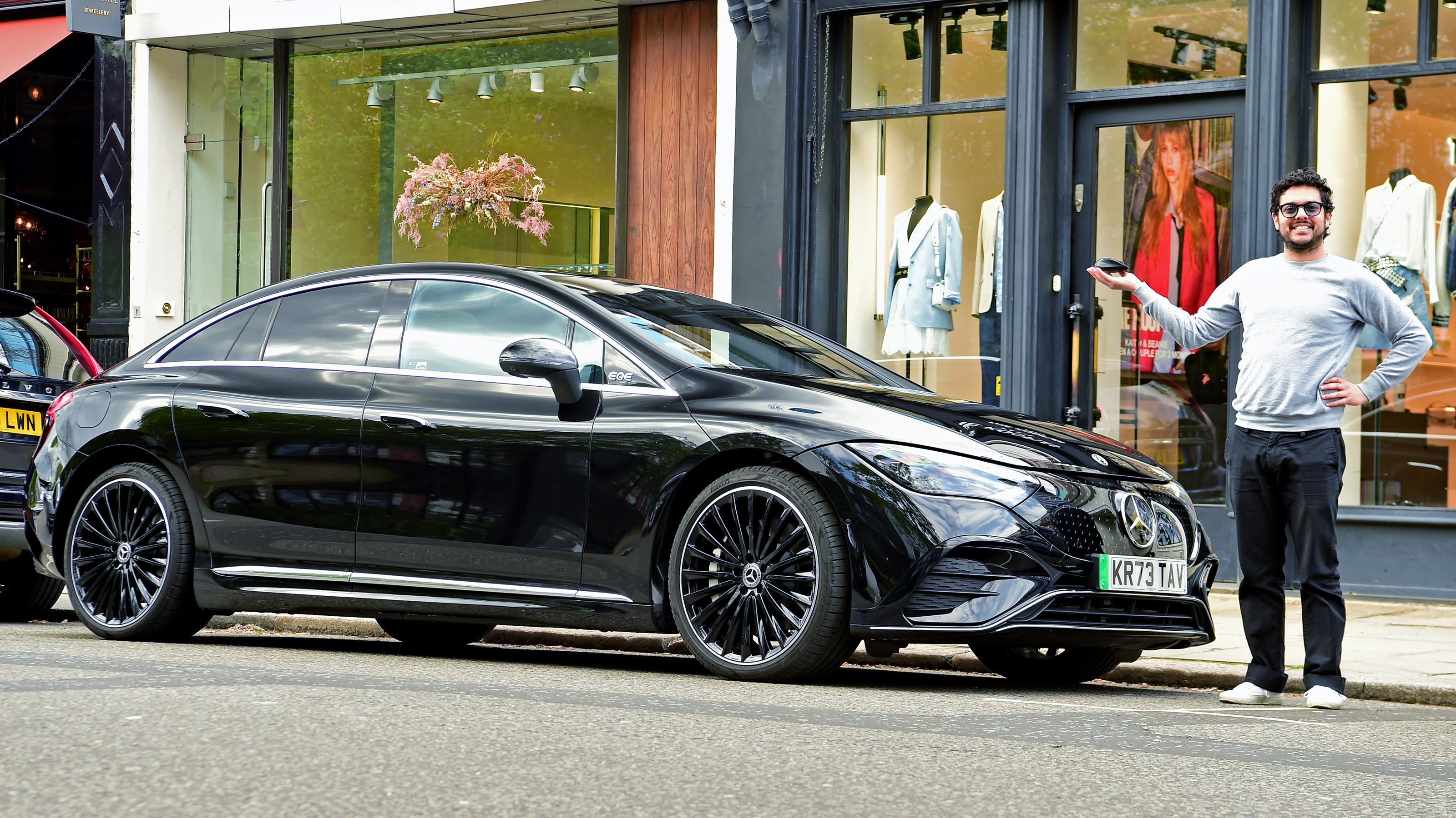 Auto Express senior staff writer Jordan Katsianis standing next to the Mercedes EQE