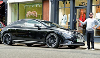 Auto Express senior staff writer Jordan Katsianis standing next to the Mercedes EQE
