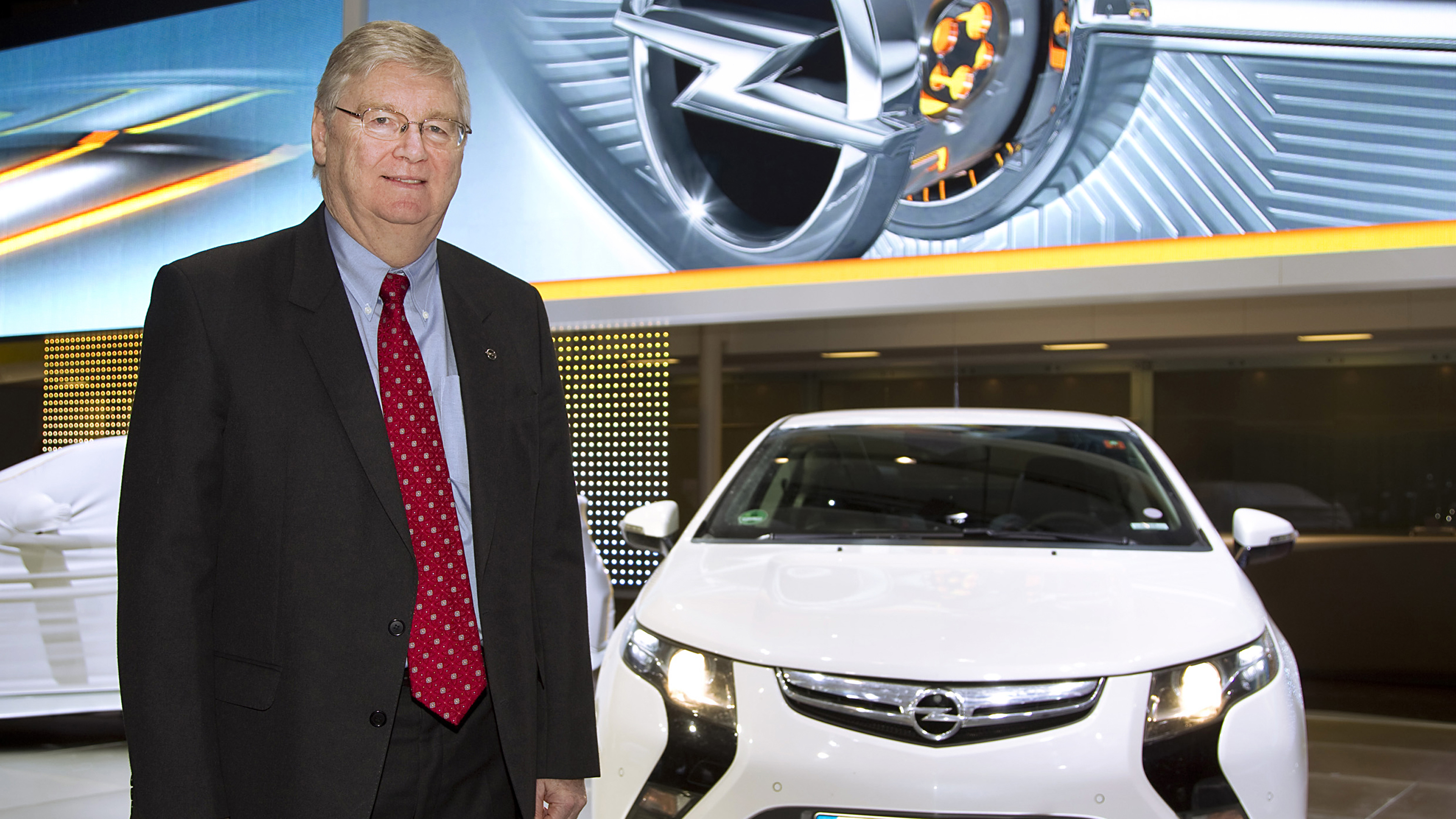 Nick Reilly standing next to an Opel Ampera