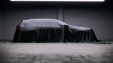 BMW M5 Touring teased - side profile under a sheet