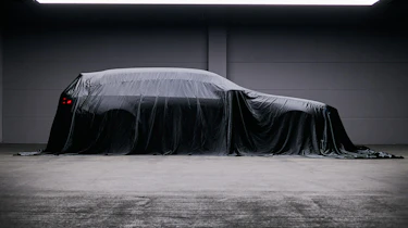 BMW M5 Touring teased - side profile under a sheet