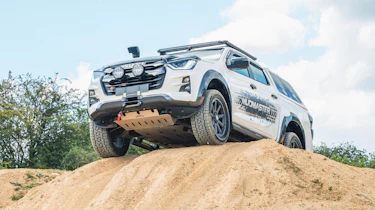 Muddied Isuzu D-Max Mudmaster - traversing hill
