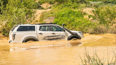 Isuzu D-Max Mudmaster - driving through muddy water (side)