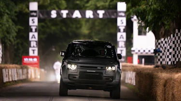 Land Rover Defender OCTA driving up the Goodwood hill climb