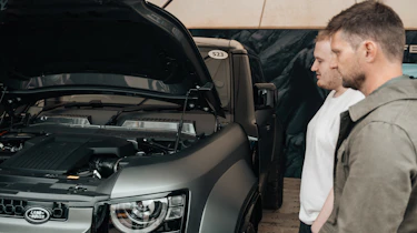 Auto Express news reporter Ellis Hyde and Shaun Birch looking at the Land Rover Defender OCTA's engine bay