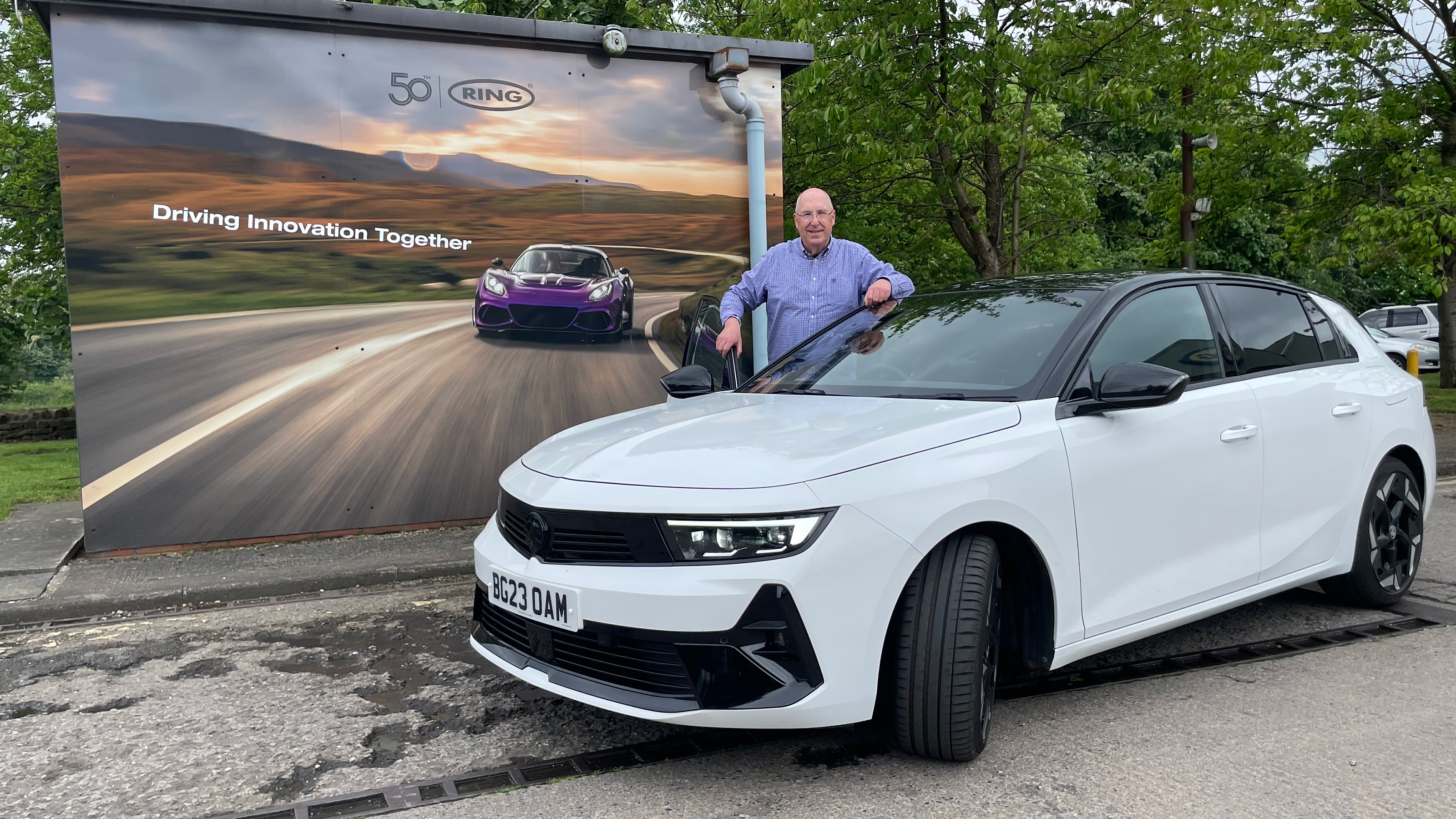 Auto Express products editor Kim Adams standing behind the Vauxhall Astra GSe