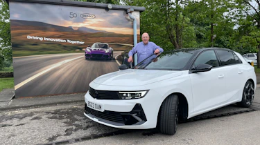 Auto Express products editor Kim Adams standing behind the Vauxhall Astra GSe