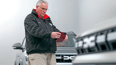Dacia owner taking a photo of the Dacia Duster's grille