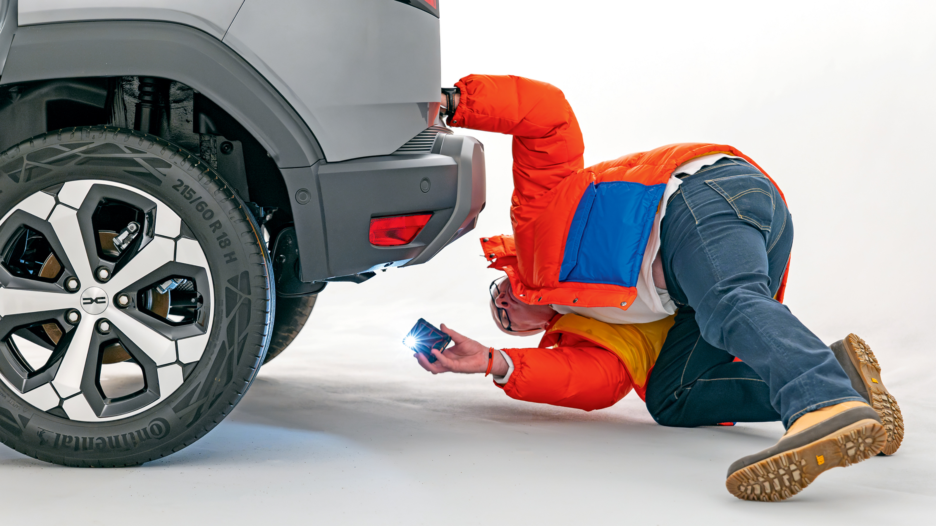 Dacia owner inspecting the Dacia Duster's rear bumper