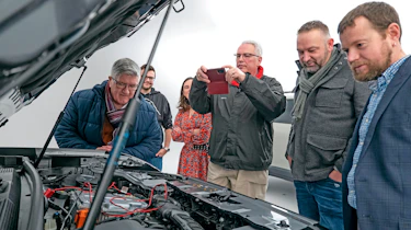 Dacia owners inspecting the Dacia Duster's engine bay