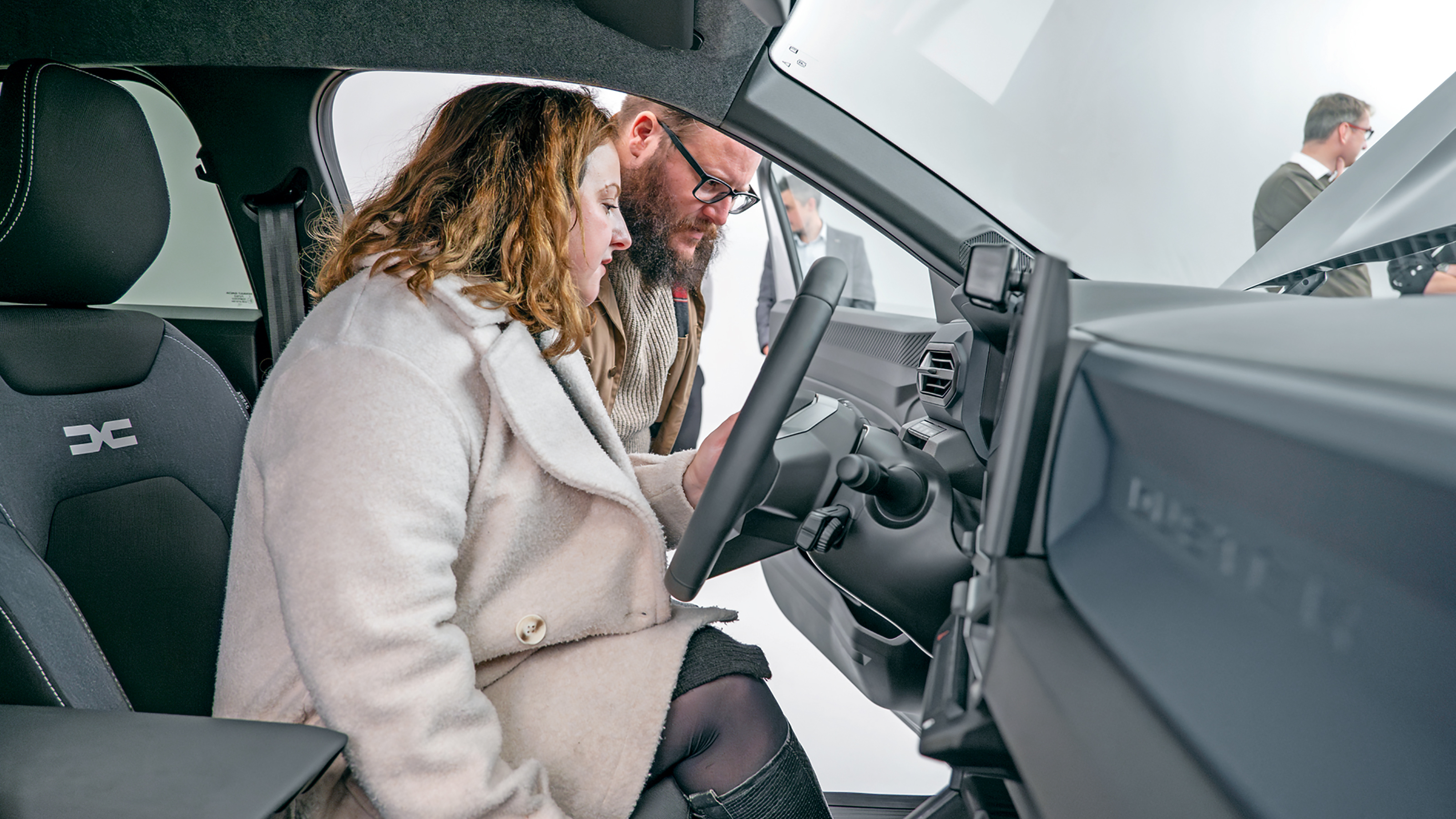 Dacia owners inspecting the Dacia Duster's steering wheel