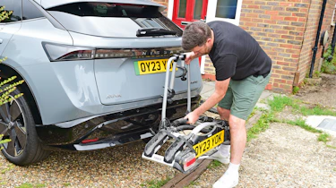 Auto Express head of digital content Steve Walker fitting a bike to the Nissan Ariya's bike rack