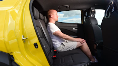 Nissan Juke - back seats being sat in by Auto Express chief reviewer Alex Ingram