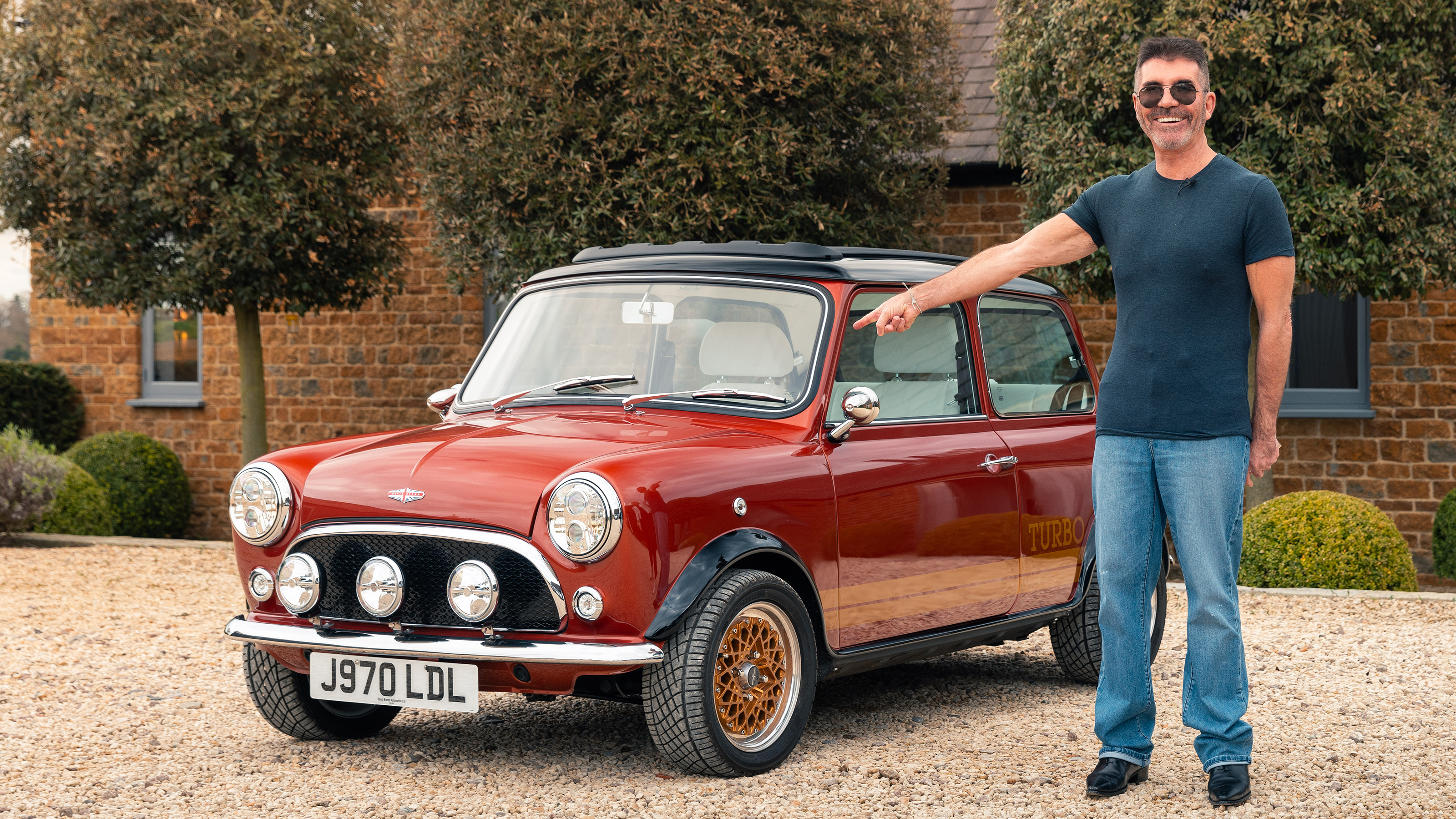 Super Mini Coopers - Simon Cowell stood next to his Mini eMastered
