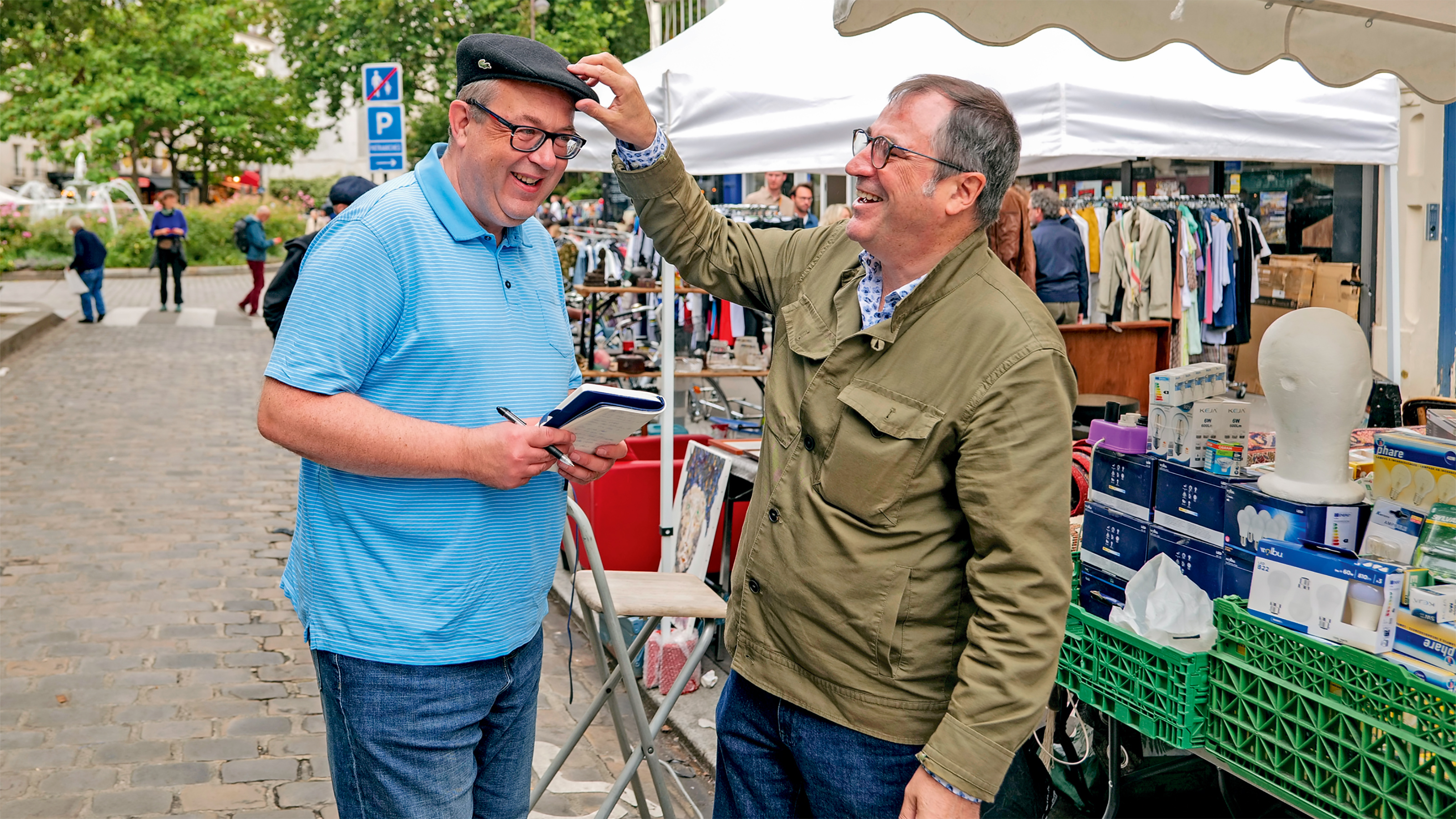 Dacia CEO Denis Le Vot fitting a hat on John McIlroy's head