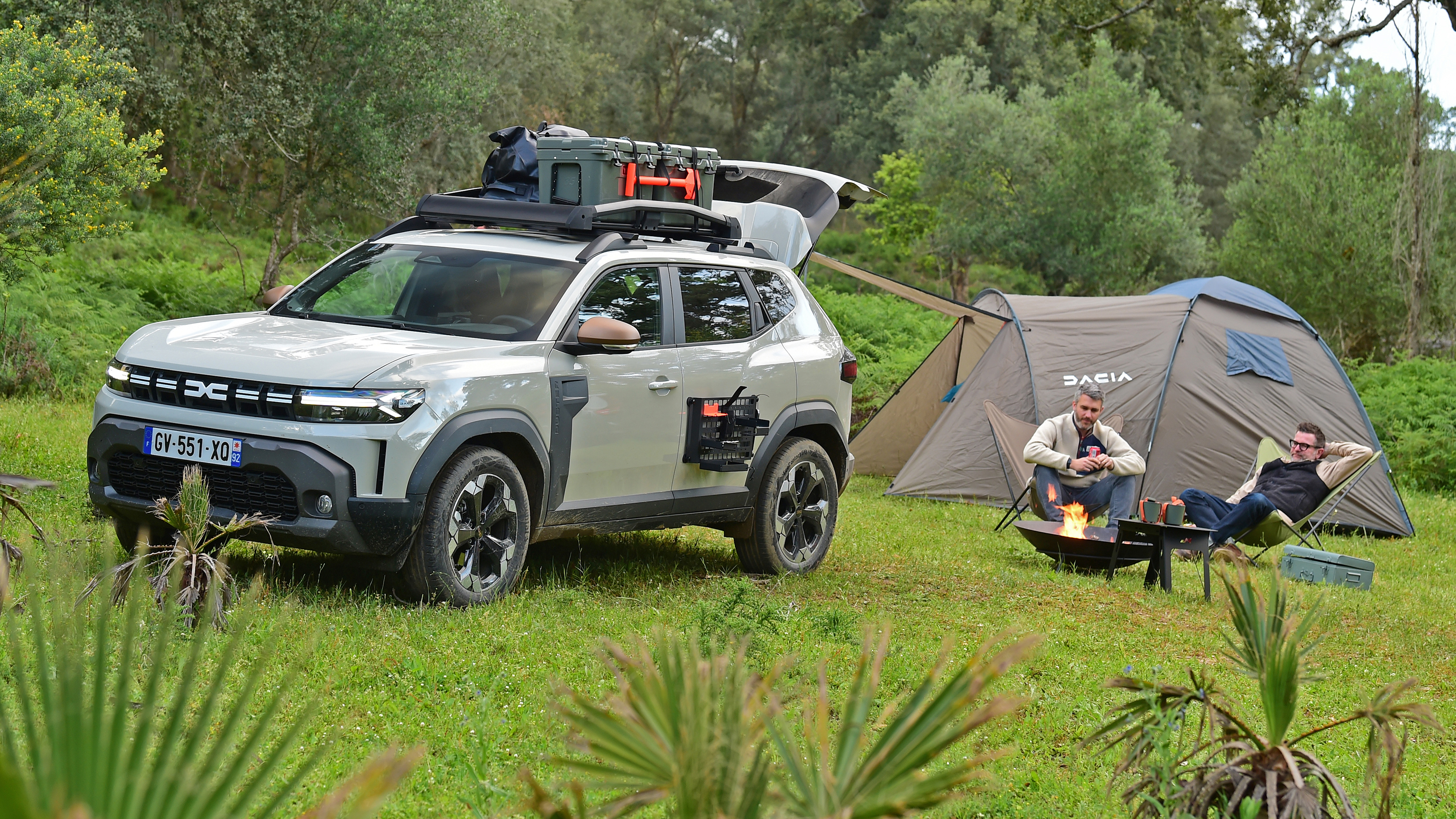Auto Express deputy editor and vice president of Dacia Design David Durand camping next to the Dacia Duster