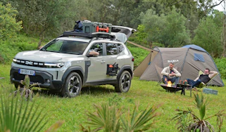 Auto Express deputy editor and vice president of Dacia Design David Durand camping next to the Dacia Duster