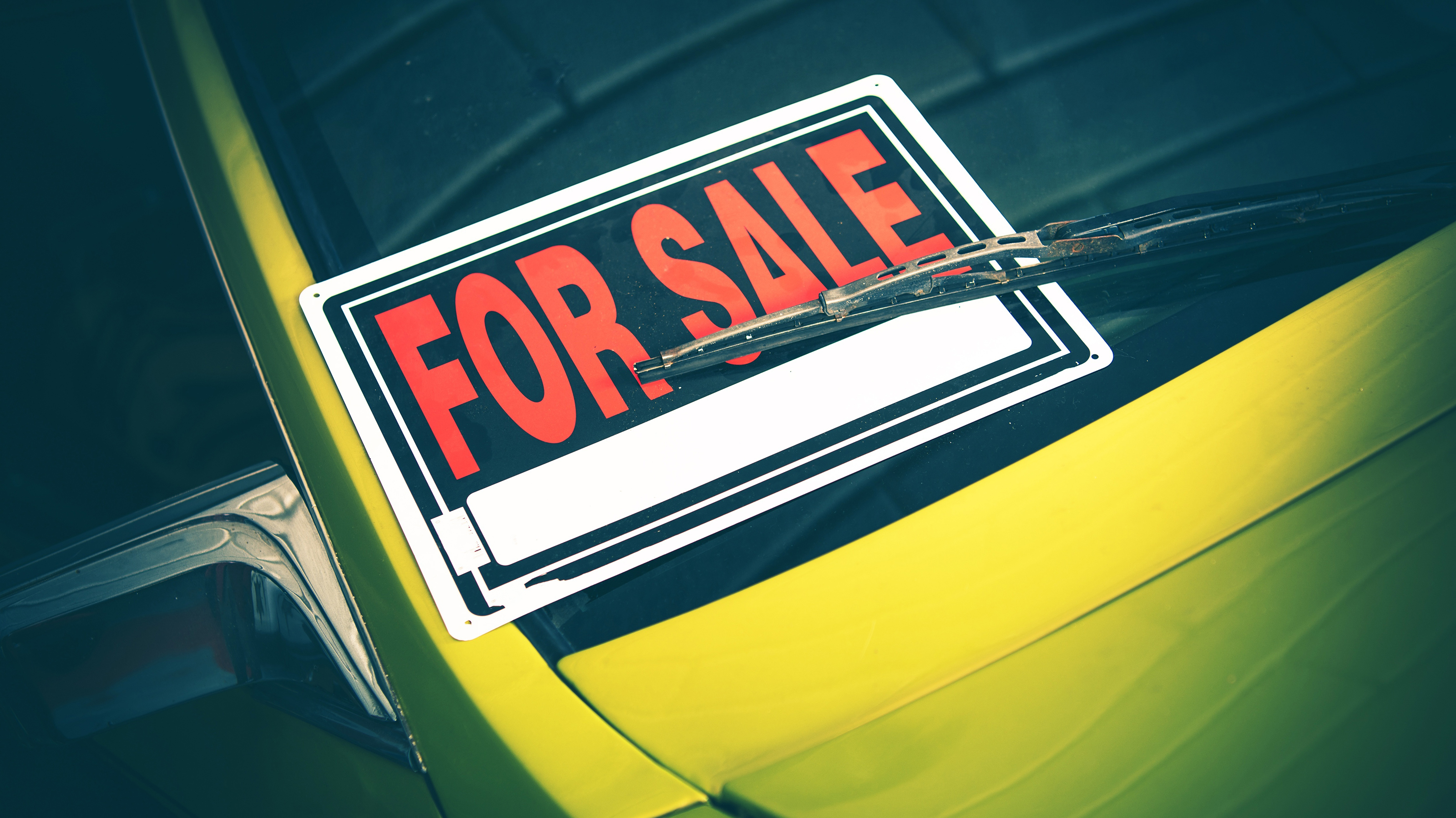'For sale' sign on car windscreen