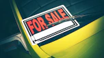 'For sale' sign on car windscreen