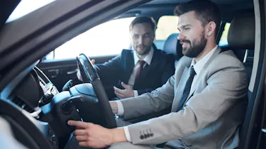 Salesperson demonstrating car to customer