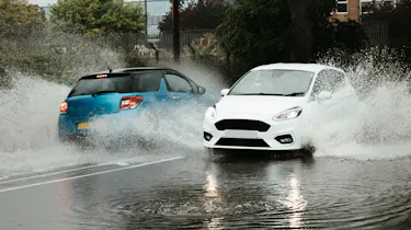 DS 3 and Ford Fiesta driving through a flood