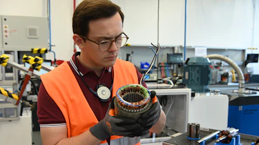 Auto Express consumer reporter Tom Jervis holding EV motor components