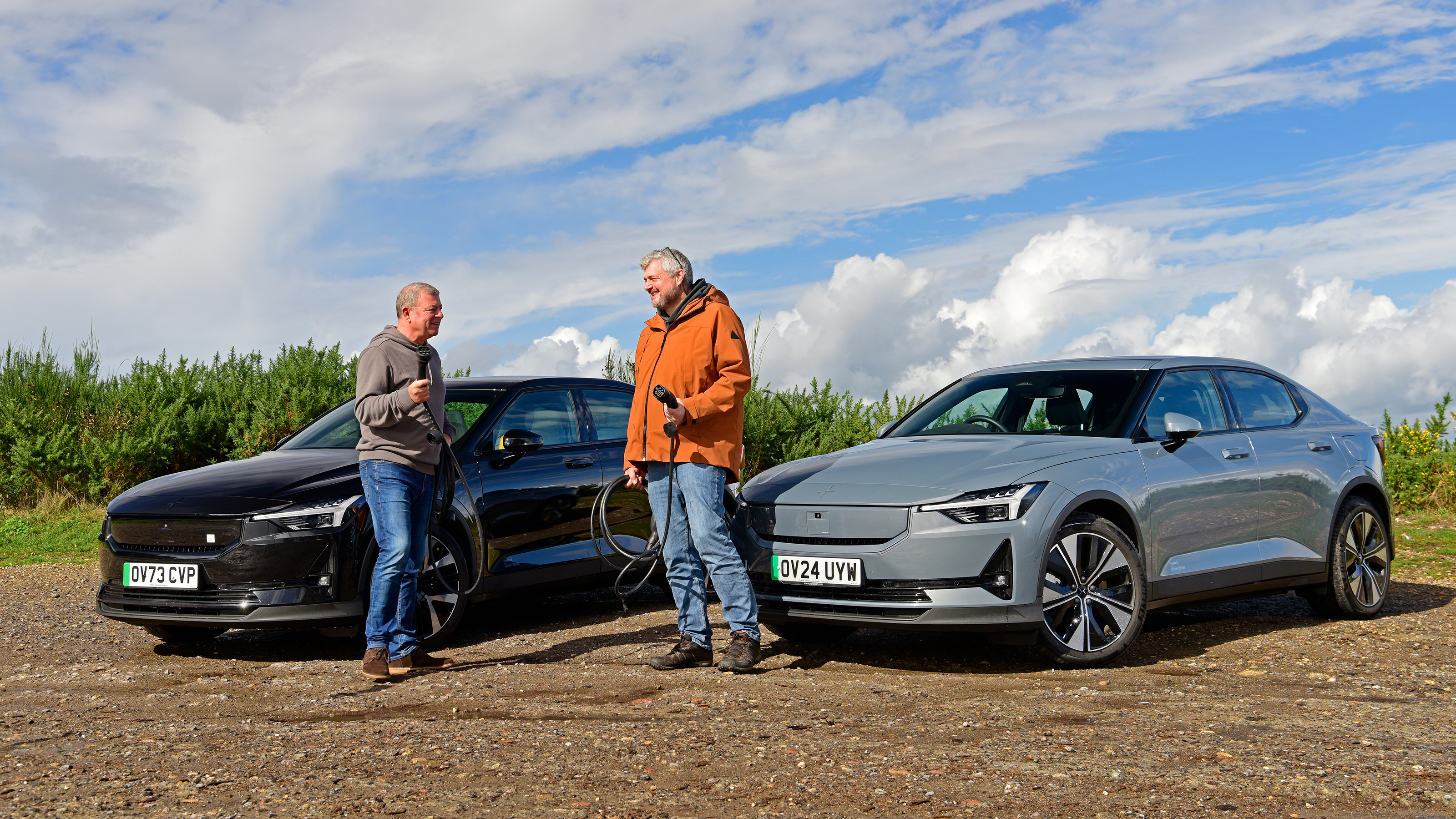 Auto Express consumer editor Chris Rosamond and contributor Steve Sutcliffe standing in front of two Polestar 2s