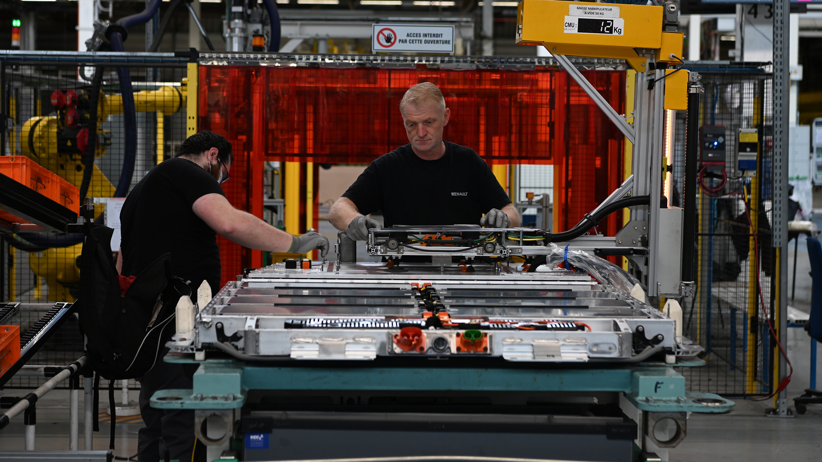 Technician's working on Renault's electric car production line