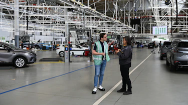 Auto Express consumer reporter Tom Jervis standing inside the Renault ReFactory facility
