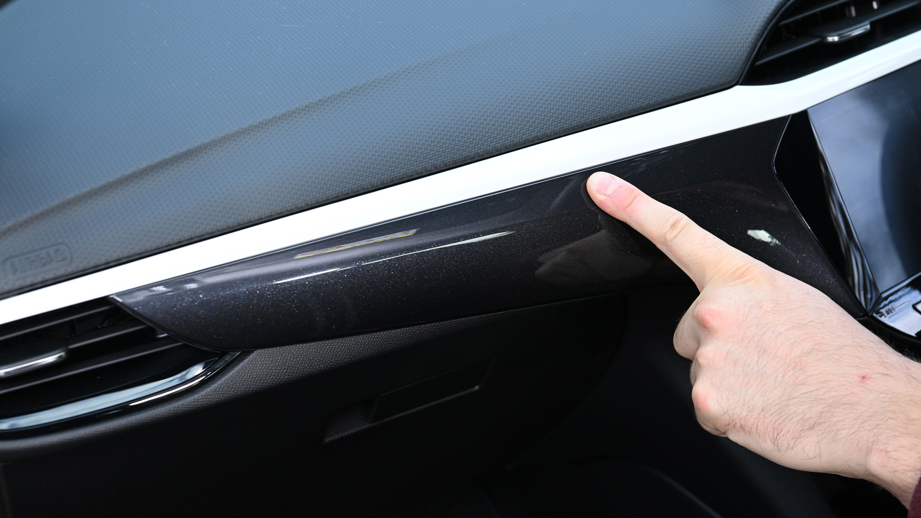 Auto Express senior news reporter Alastair Crooks touching the Vauxhall Corsa's dashboard