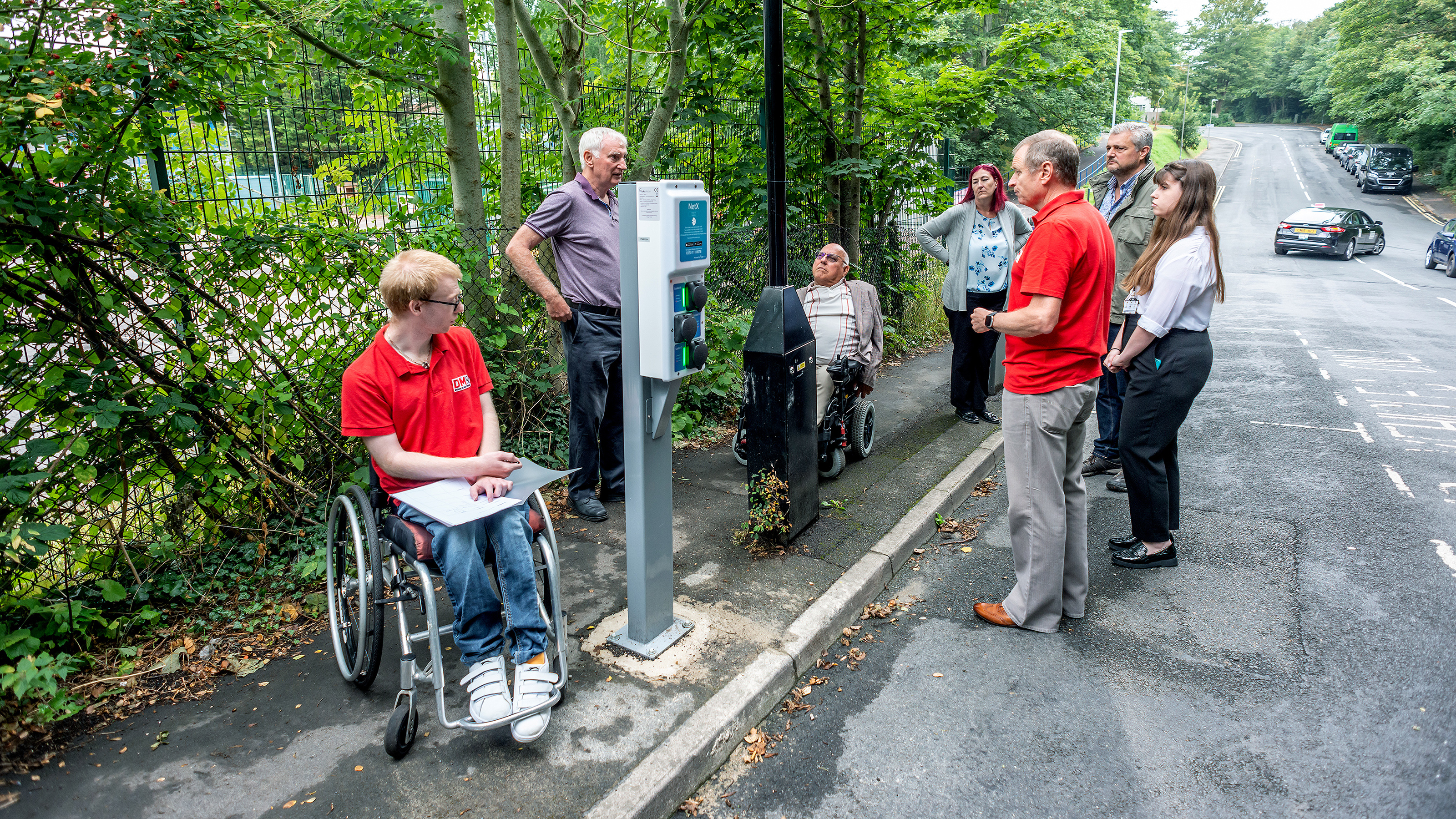 EV drivers surrounding a charging point