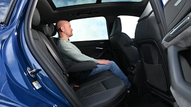 Audi Q6 e-tron - rear seats being sat in by Auto Express chief reviewer Alex Ingram