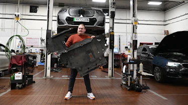Auto Express news reporter Ellis Hyde standing in a BMW workshop