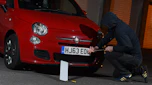 Thief stealing a Fiat 500's number plate