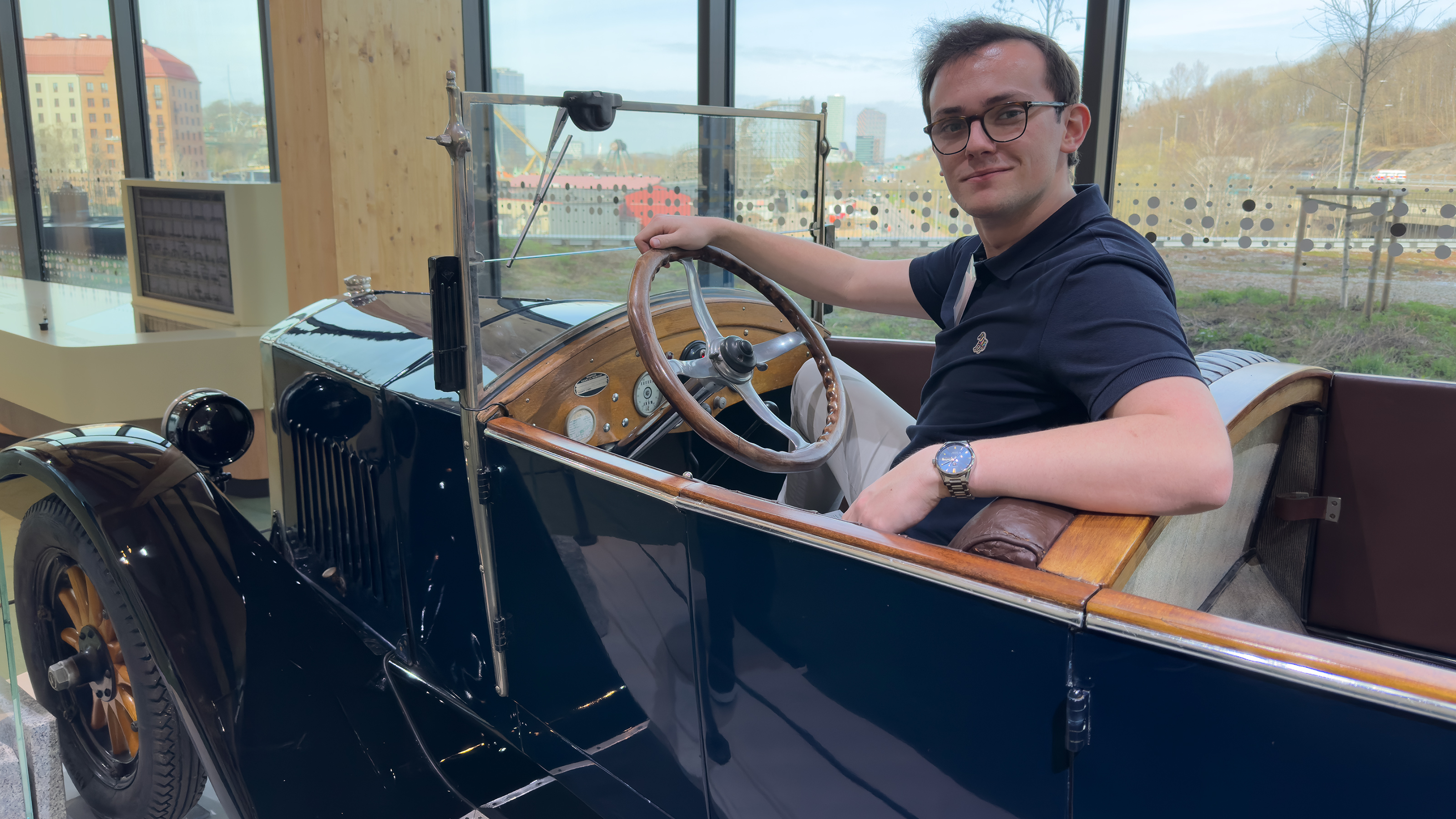 Auto Express consumer reporter Tom Jervis sitting in a vintage Volvo