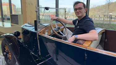 Auto Express consumer reporter Tom Jervis sitting in a vintage Volvo