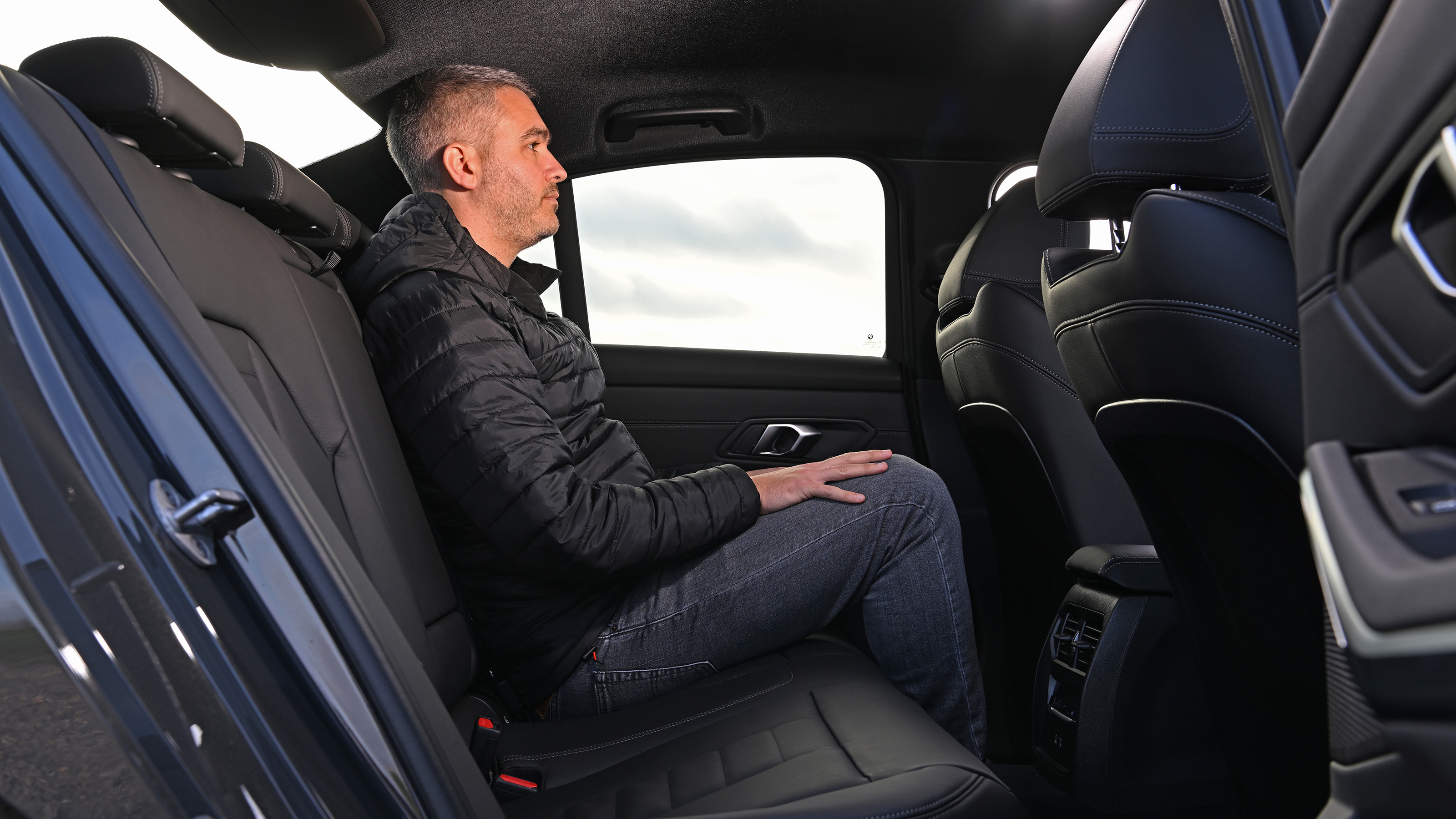 Auto Express deputy editor Richard Ingram sitting in the BMW 330e's rear seats