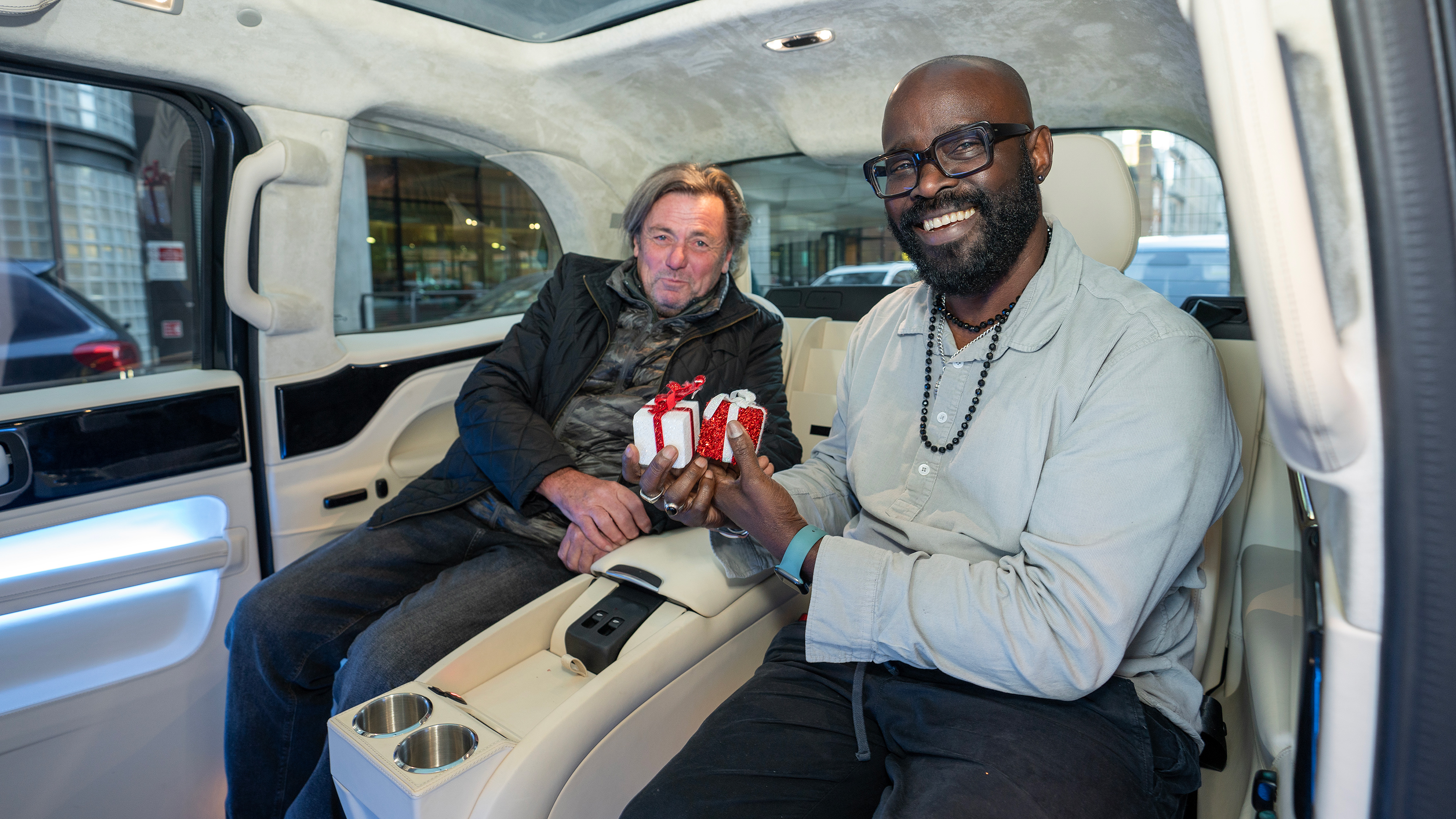 Auto Express chief columnist Mike Rutherford and Johnny H sitting in the Clive Sutton LEVC TX's back seats