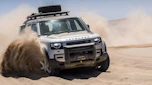 Land Rover Defender driving through sand