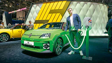 Auto Express senior news reporter Alastair Crooks holding a Renault 5's charging cable
