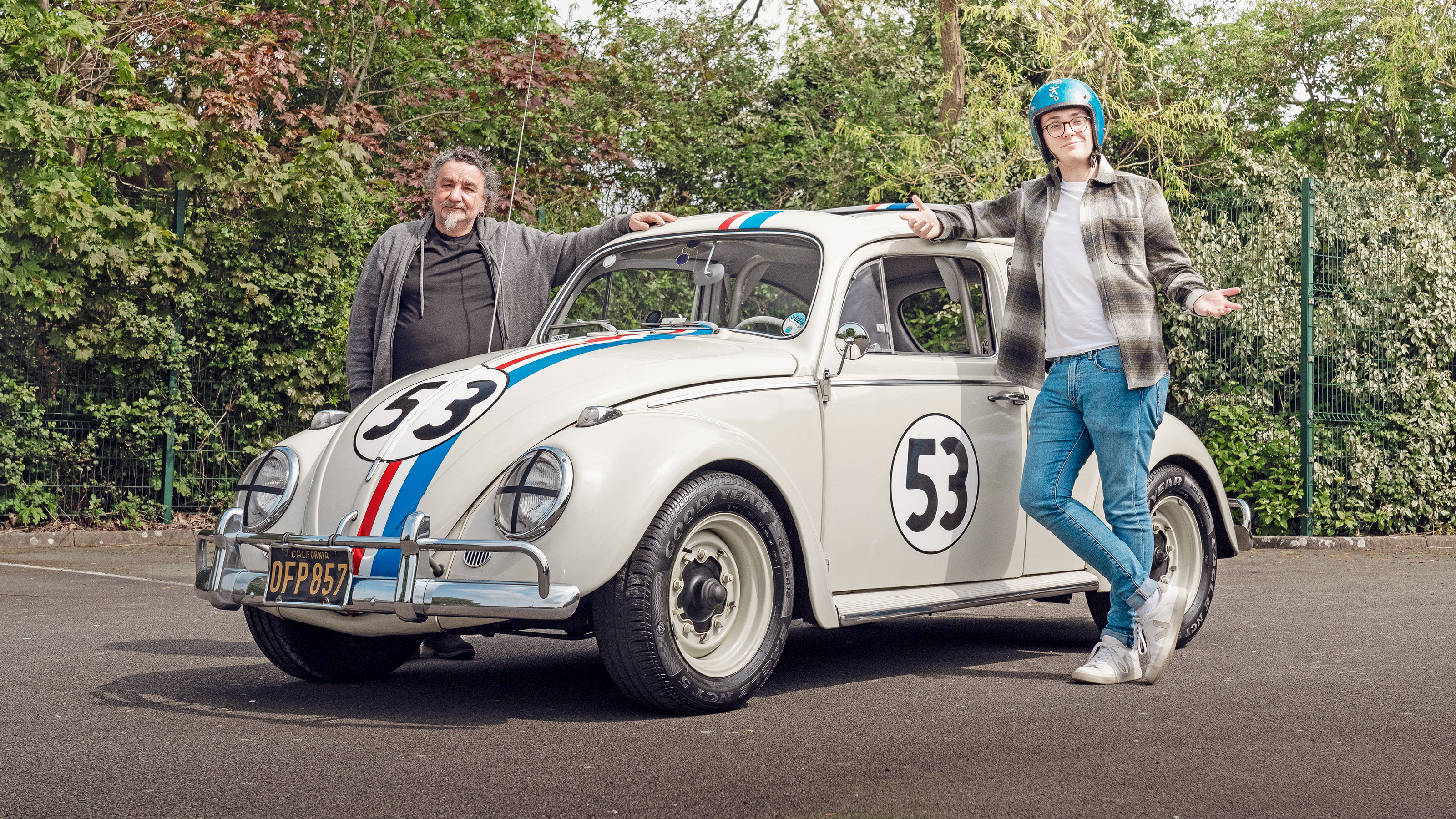 Auto Express consumer reporter Tom Jervis standing next to a 'Herbie' Volkswagen Beetle