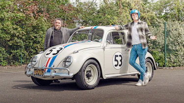 Auto Express consumer reporter Tom Jervis standing next to a 'Herbie' Volkswagen Beetle