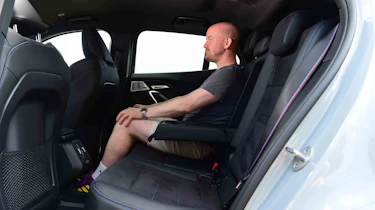 BMW iX2 - rear seats with Chief reviewer, Alex Ingram