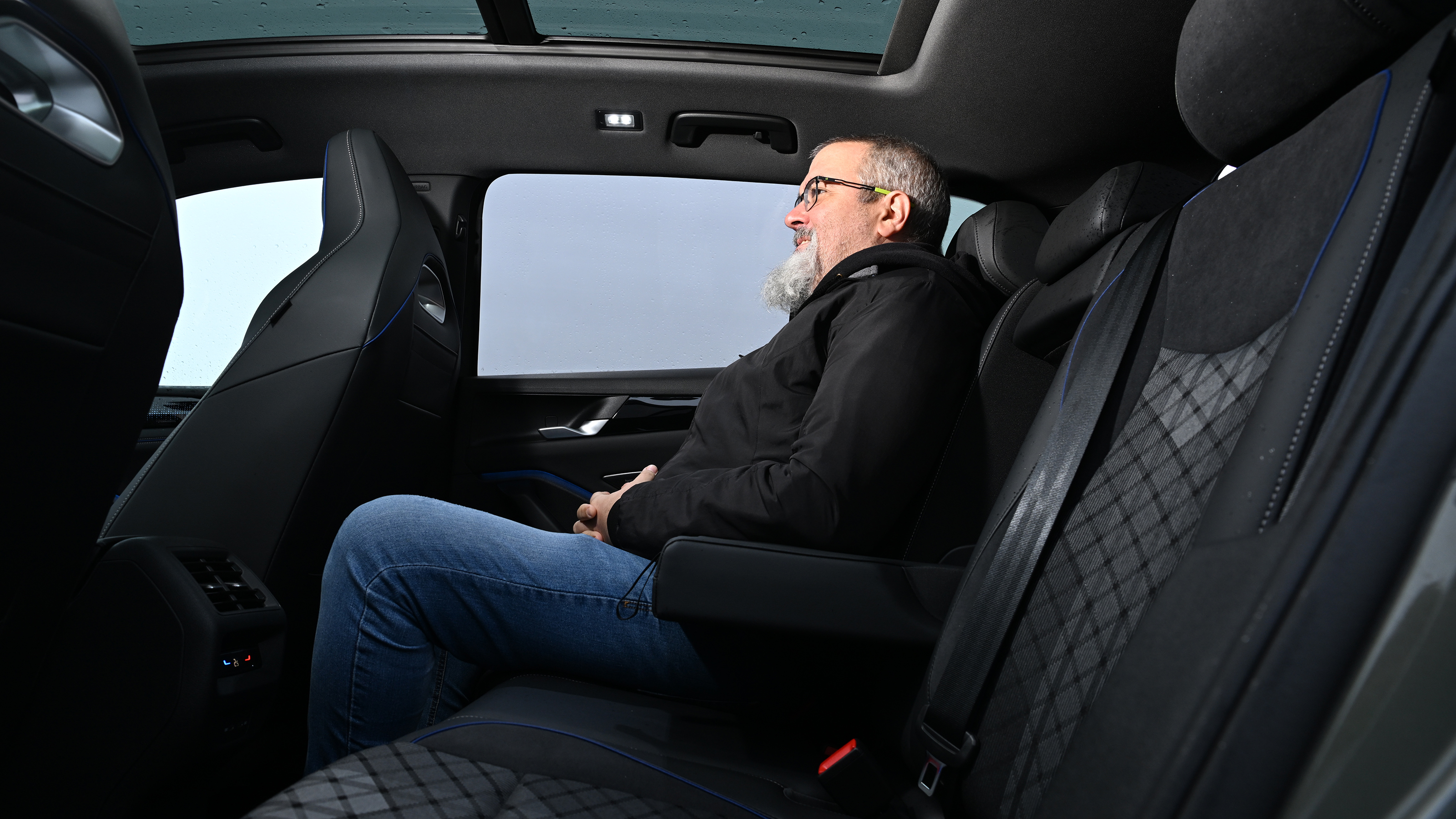 Auto Express senior test editor Dean Gibson sitting in the Volkswagen Tiguan's back seat 