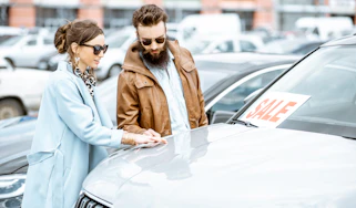 Two people inspecting a car