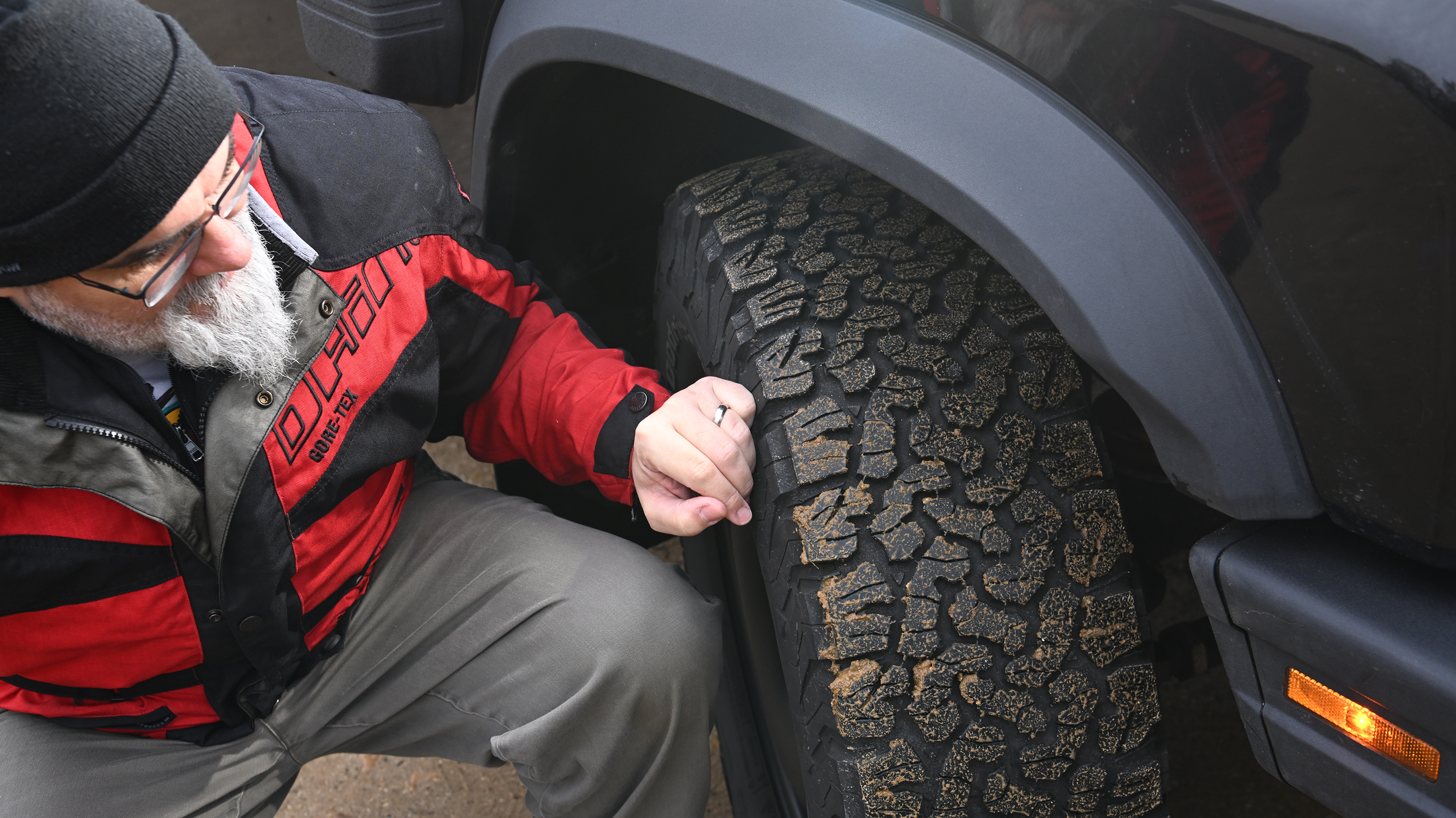 Auto Express senior test editor Dean Gibson inspecting the Ineos Grenadier's tyre