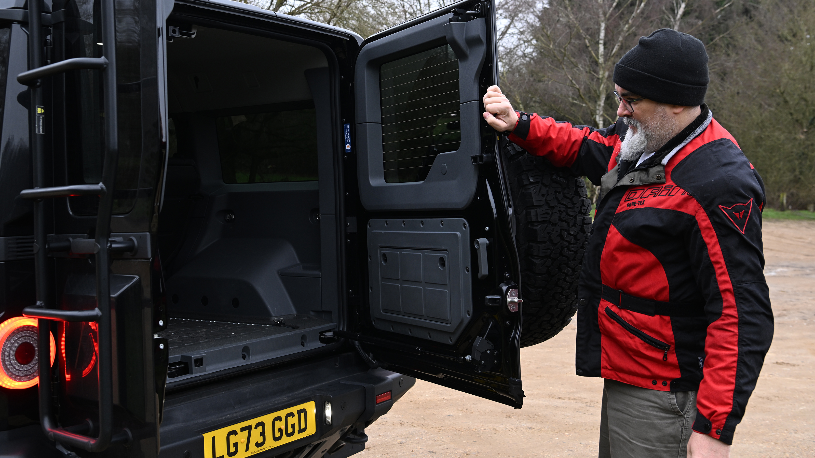 Auto Express senior test editor Dean Gibson inspecting the Ineos Grenadier's boot