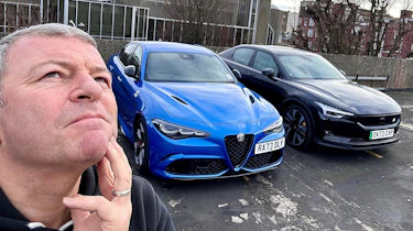 Steve Sutcliffe standing next to an Alfa Romeo Giulia Quadrifoglio and Polestar 2