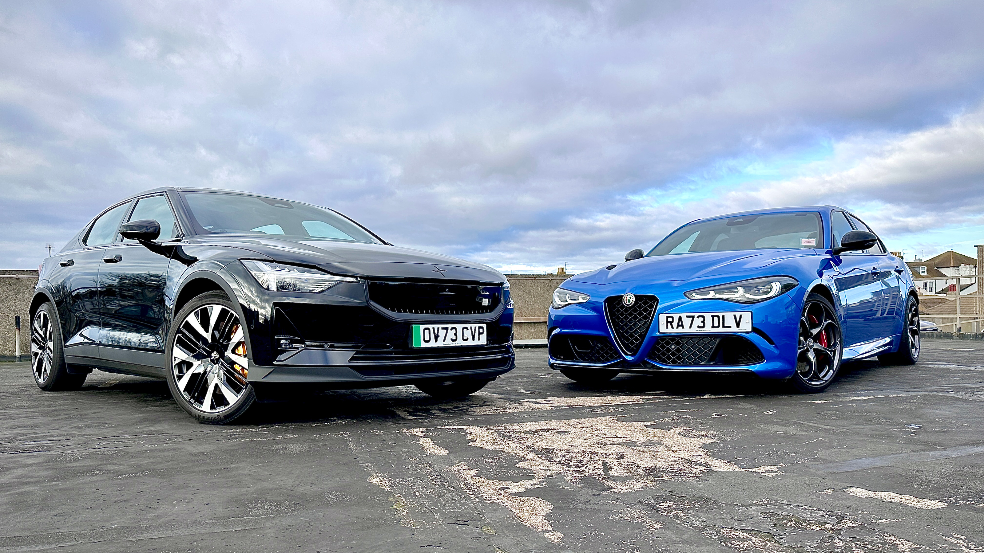 Steve Sutcliffe standing next to an Alfa Romeo Giulia Quadrifoglio and Polestar 2
