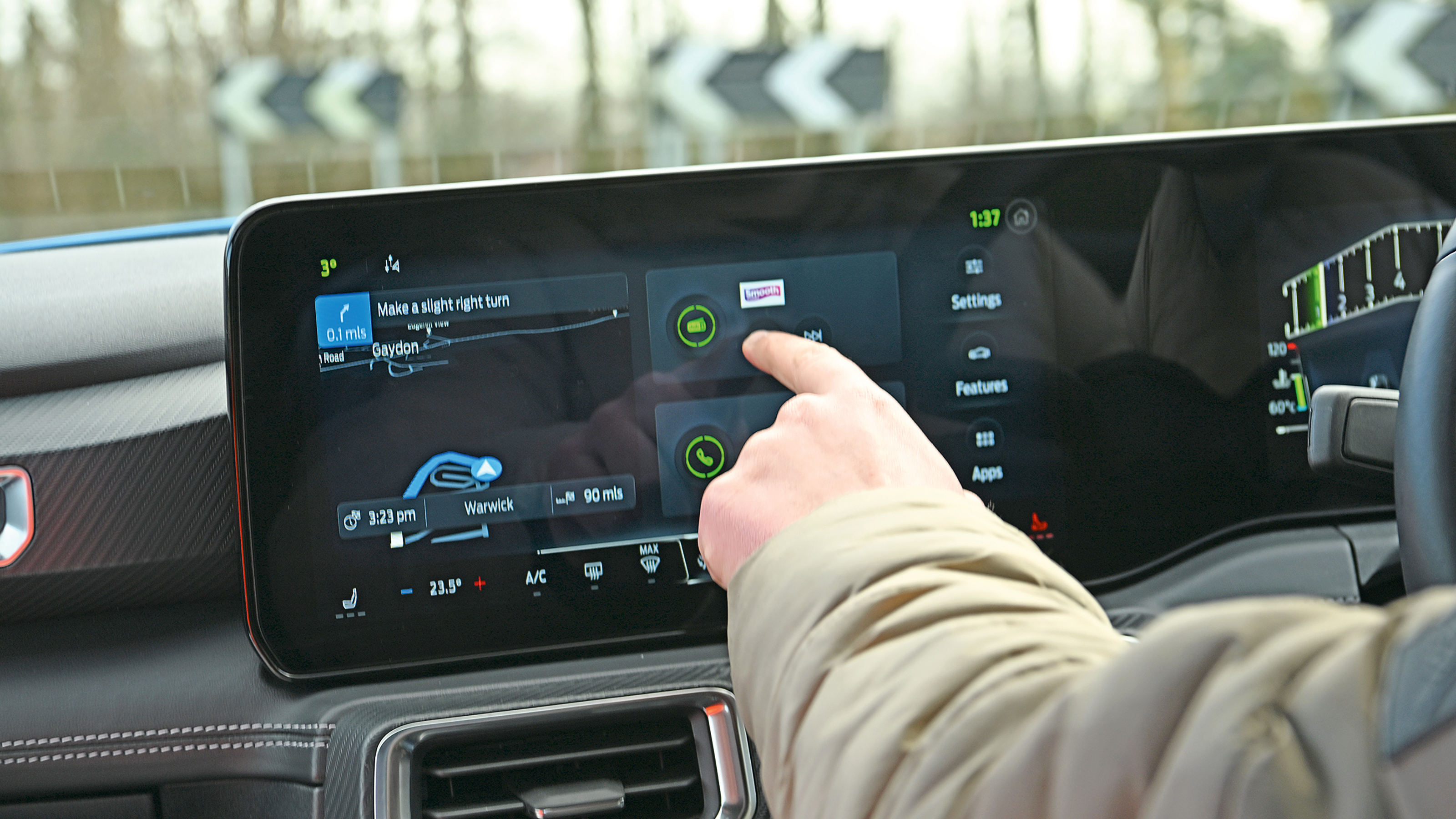 Auto Express senior content editor Shane Wilkinson operating the Ford Mustang's infotainment system
